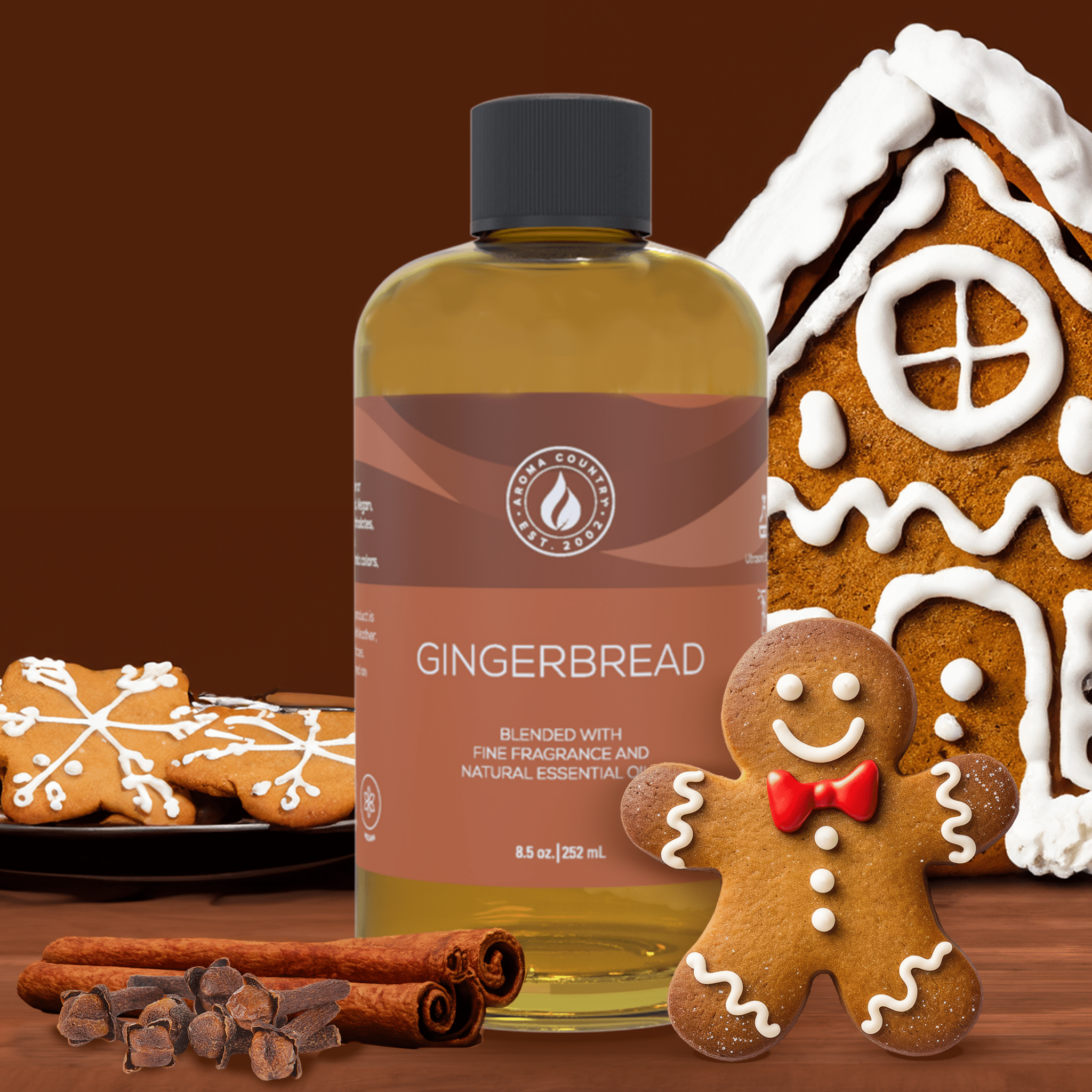 8.5 oz Gingerbread diffuser oil by Aroma Country surrounded by gingerbread cookies, cinnamon sticks, and festive holiday accents for a cozy seasonal aroma.