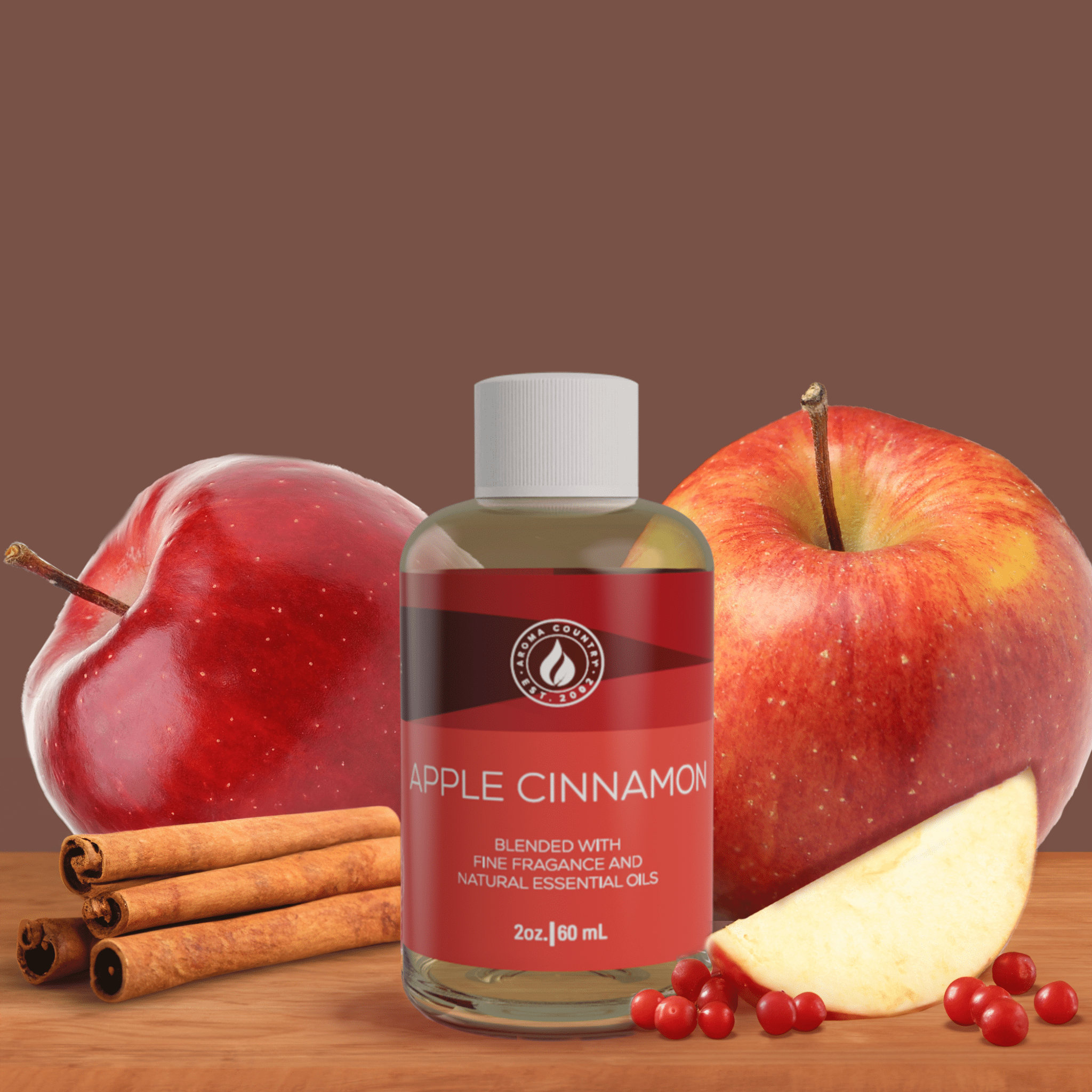 2 oz Apple Cinnamon diffuser oil from Aroma Country surrounded by apples, cinnamon sticks, and berries—crafted with essential oils and warm seasonal fragrance.