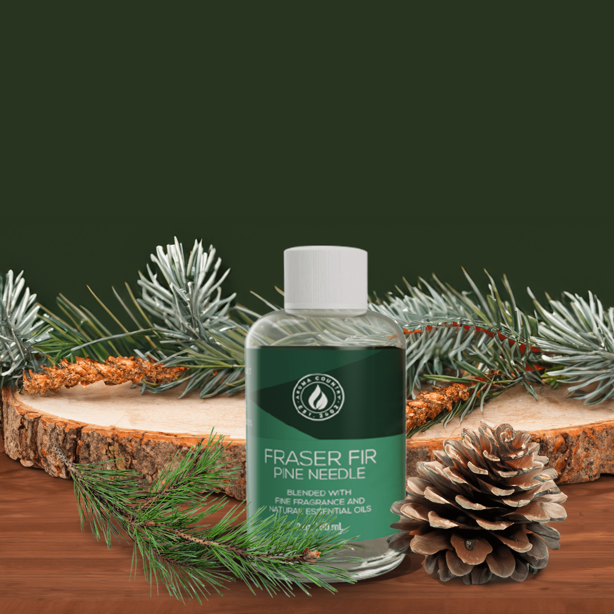 2 oz Fraser Fir Pine Needle diffuser oil by Aroma Country, displayed with pinecones, fir branches, and a wood slice for a festive, woodland-inspired atmosphere.