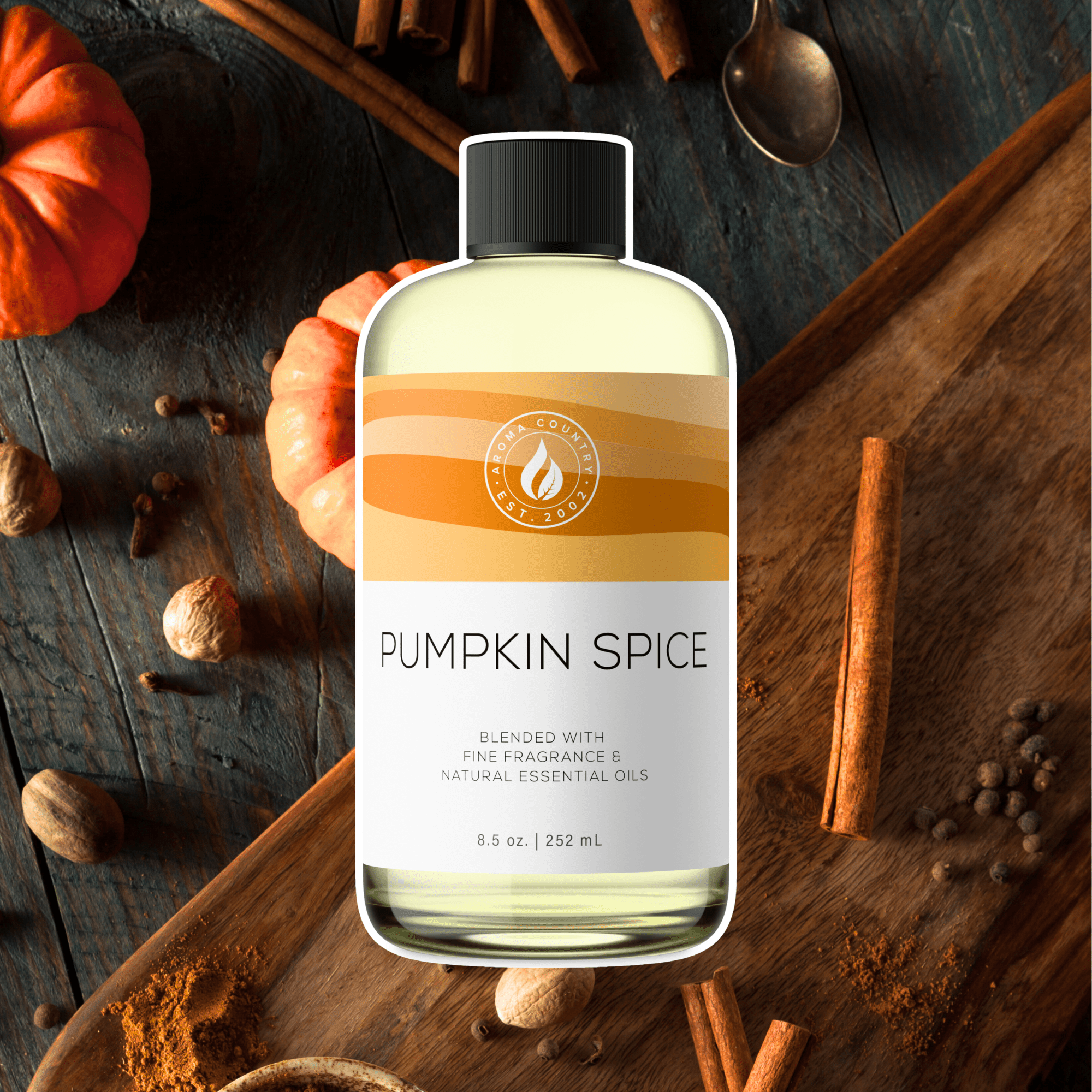Pumpkin Spice diffuser oil with cinnamon and nutmeg on rustic wood, evoking cozy fall home fragrance.