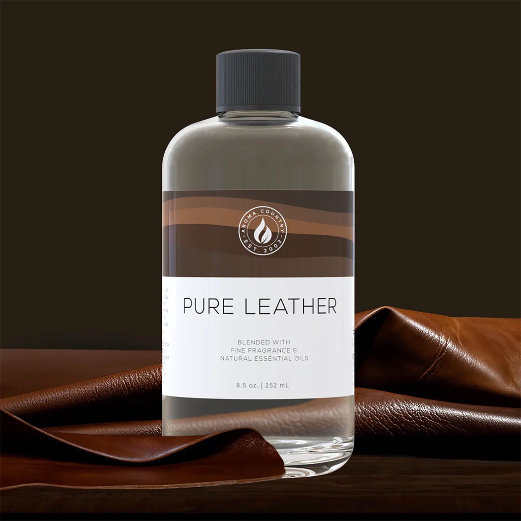 Pure Leather diffuser oil 8.5 oz bottle displayed on rich brown leather, evoking the scent’s bold, masculine essence with refined fragrance and essential oils.